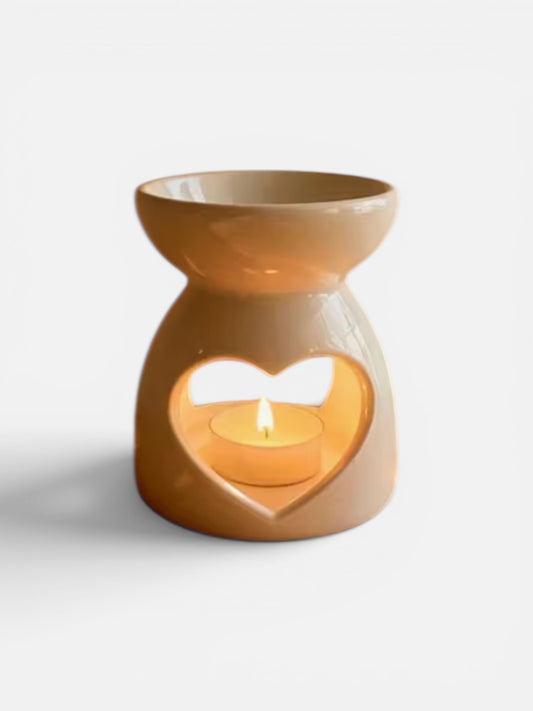 Ceramic oil burner with heart-shaped cutout on a white background