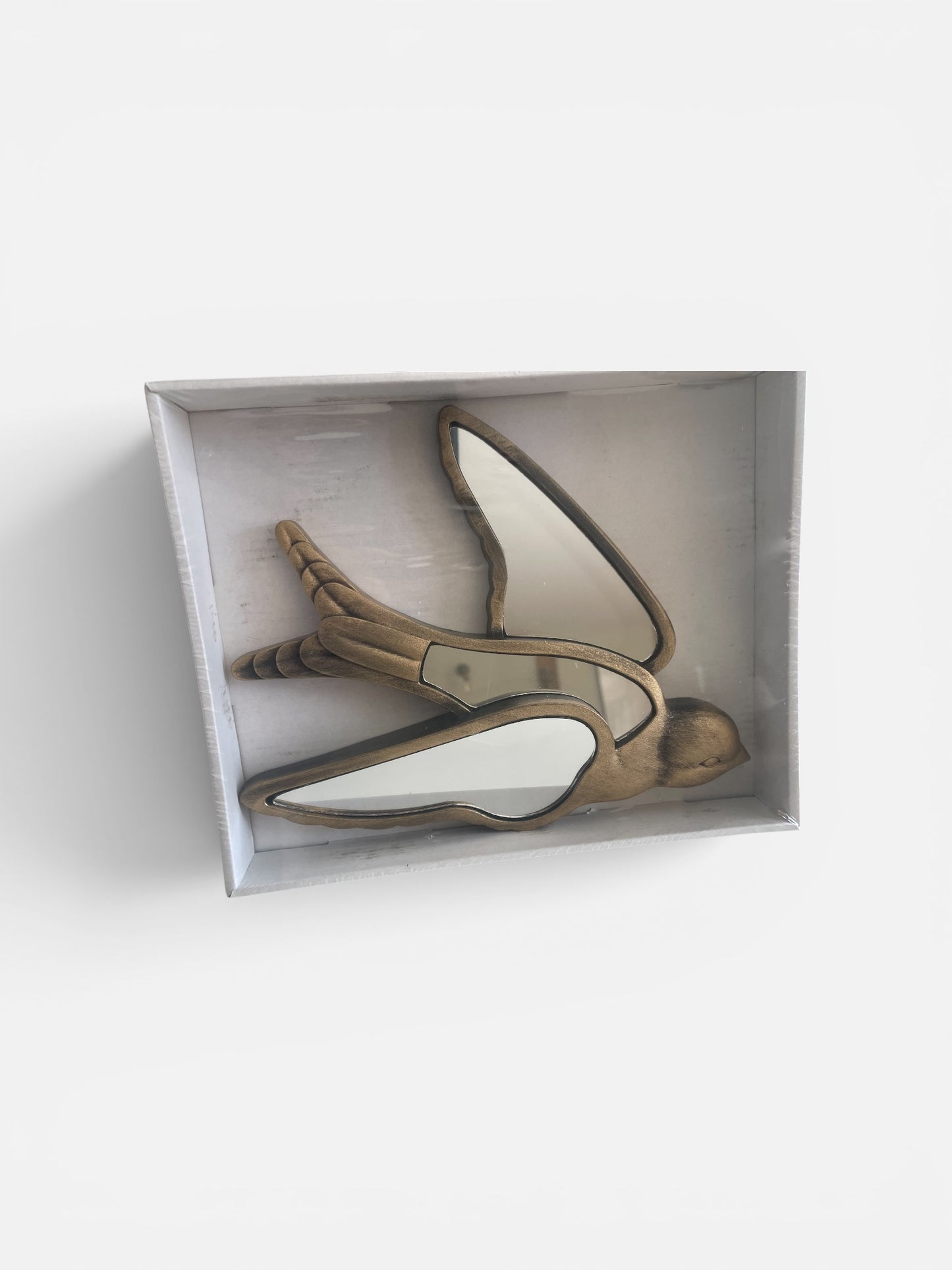 Pair of high-heeled shoes in a box on a white background