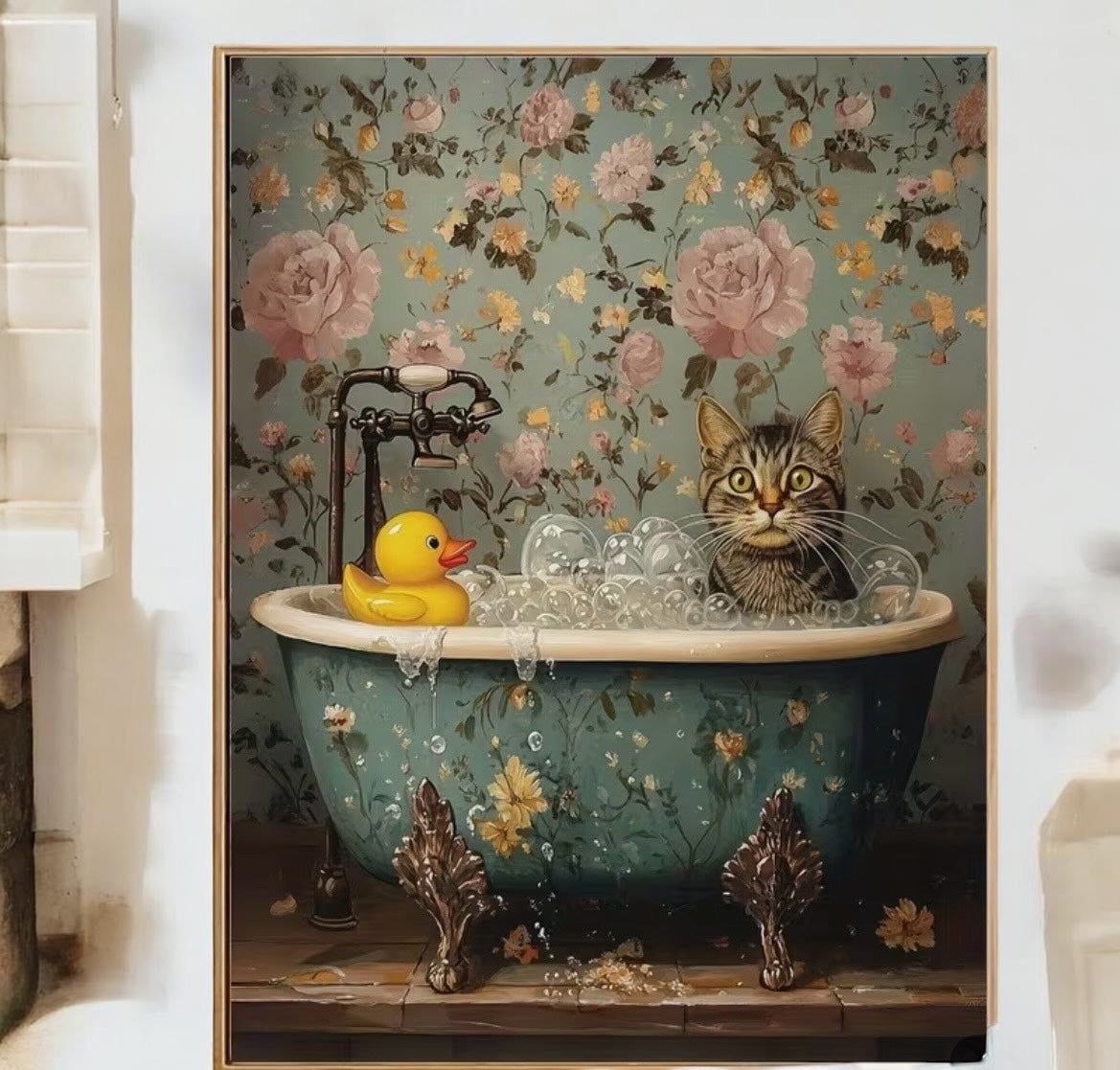 Framed artwork of a cat in a bathtub with a rubber duck against a floral background