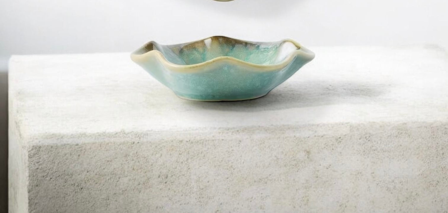 Green ceramic bowl on a white surface