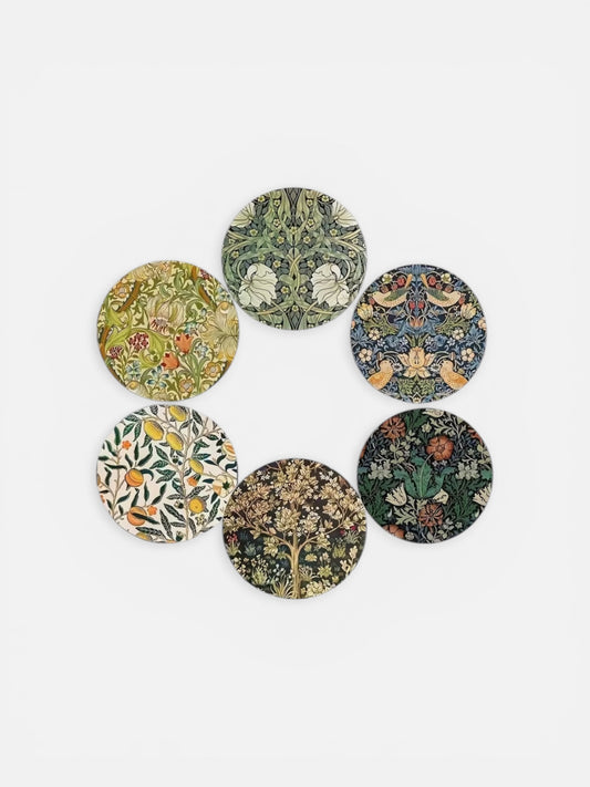 Set of six circular coasters with floral and nature-themed designs on a white background