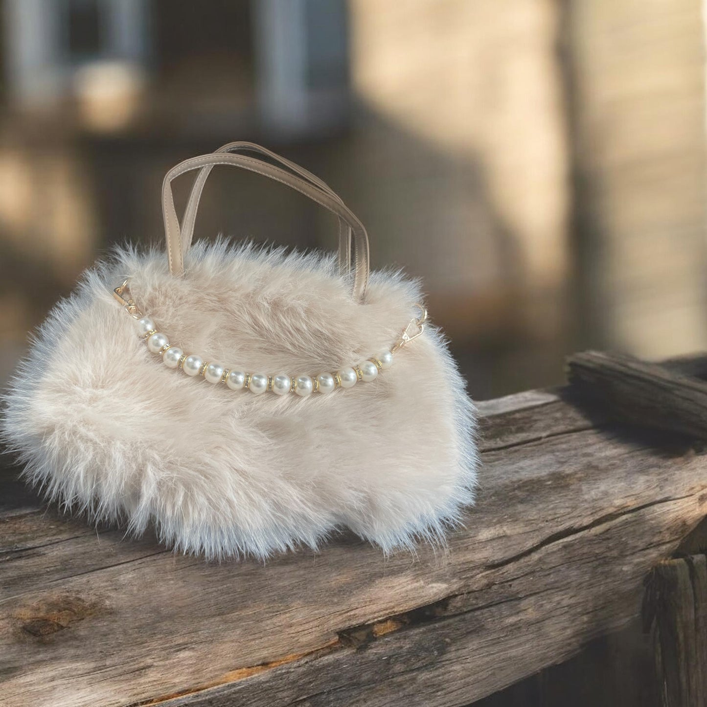Fluffy white handbag with pearl details on a wooden surface