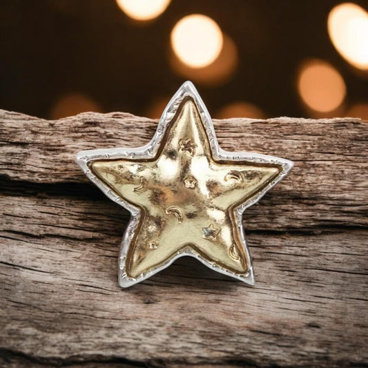 Star-shaped object on a wooden surface with blurred lights in the background