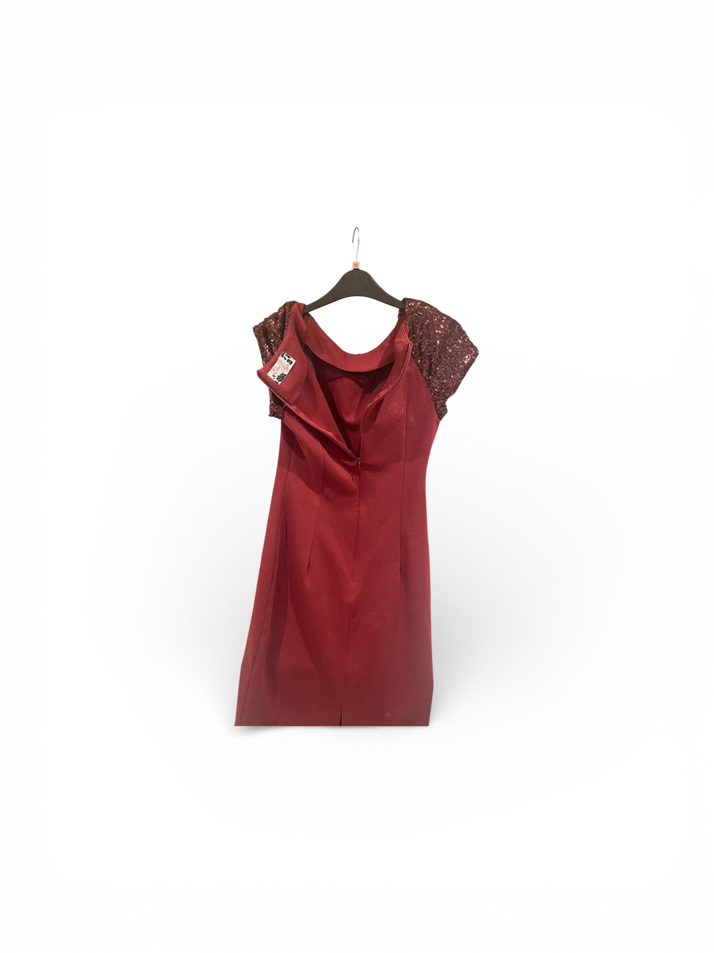 Red dress with lace sleeves on a hanger against a white background