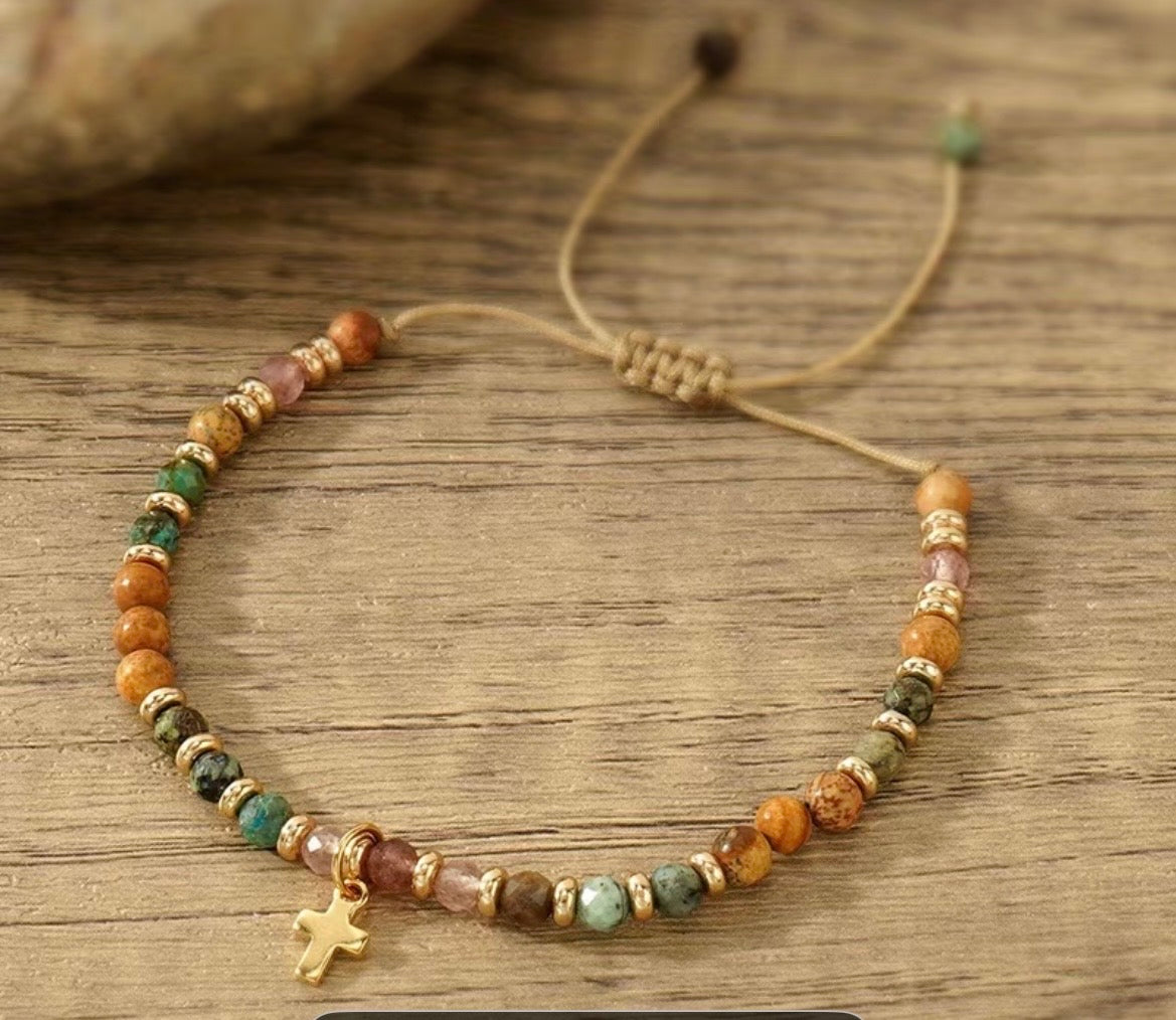 Beaded bracelet with colorful beads and a star charm on a wooden surface
