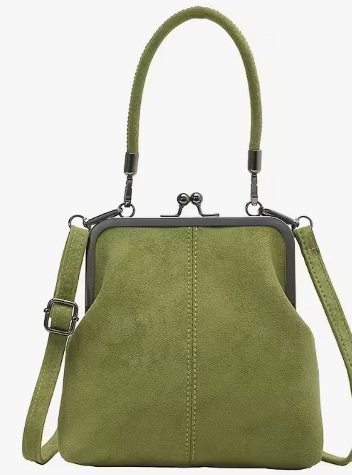 Green handbag with a strap on a white background