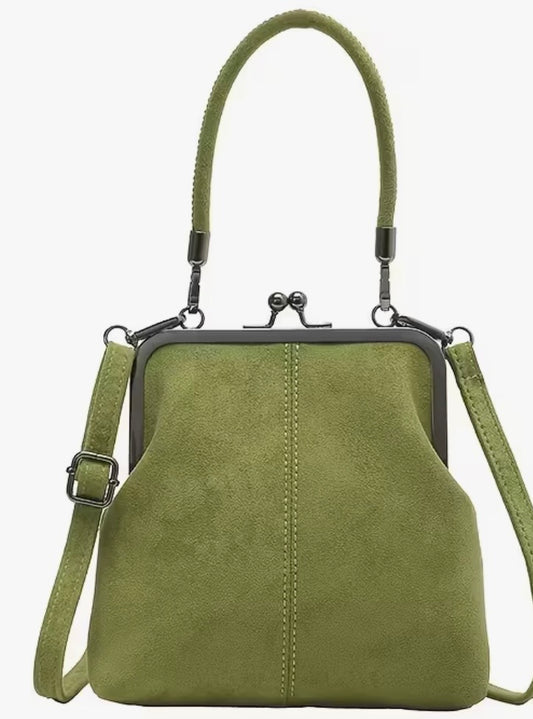 Green handbag with a strap on a white background