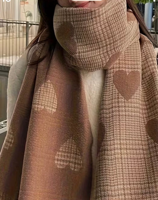Brown plaid scarf with heart patterns worn by a person.
