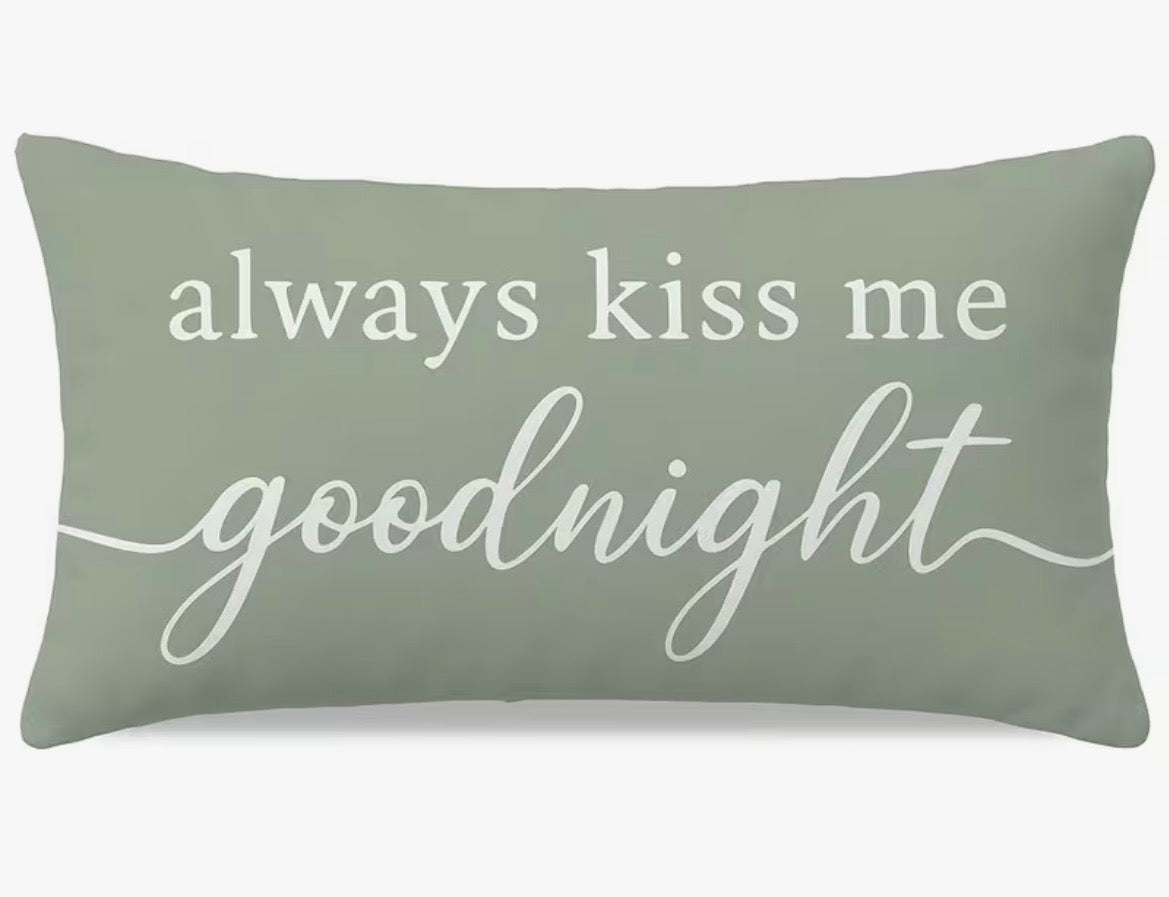 Green pillow with 'always kiss me goodnight' text on a white background
