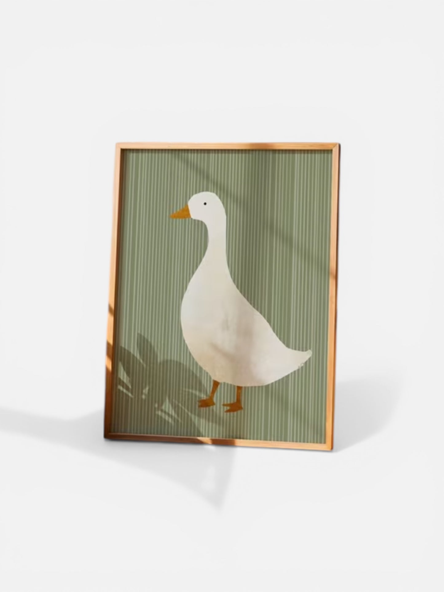 Framed artwork of a duck on a green striped background
