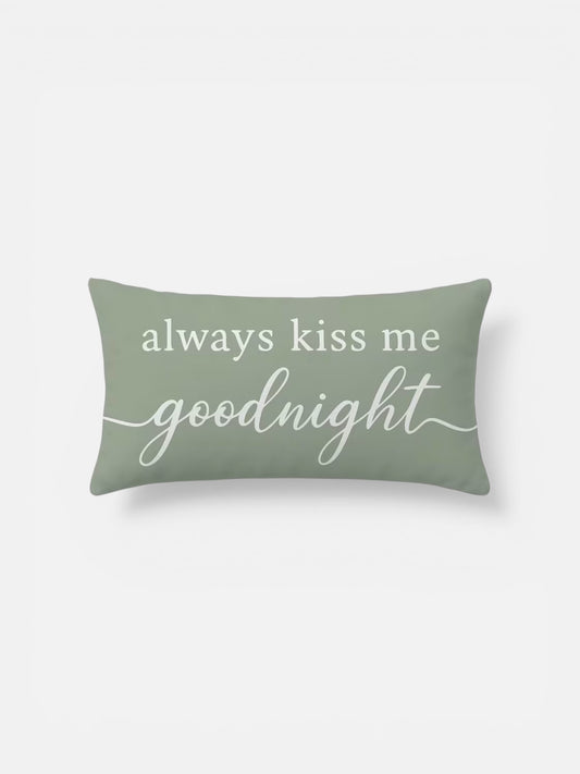 Green pillow with 'always kiss me goodnight' text on a white background