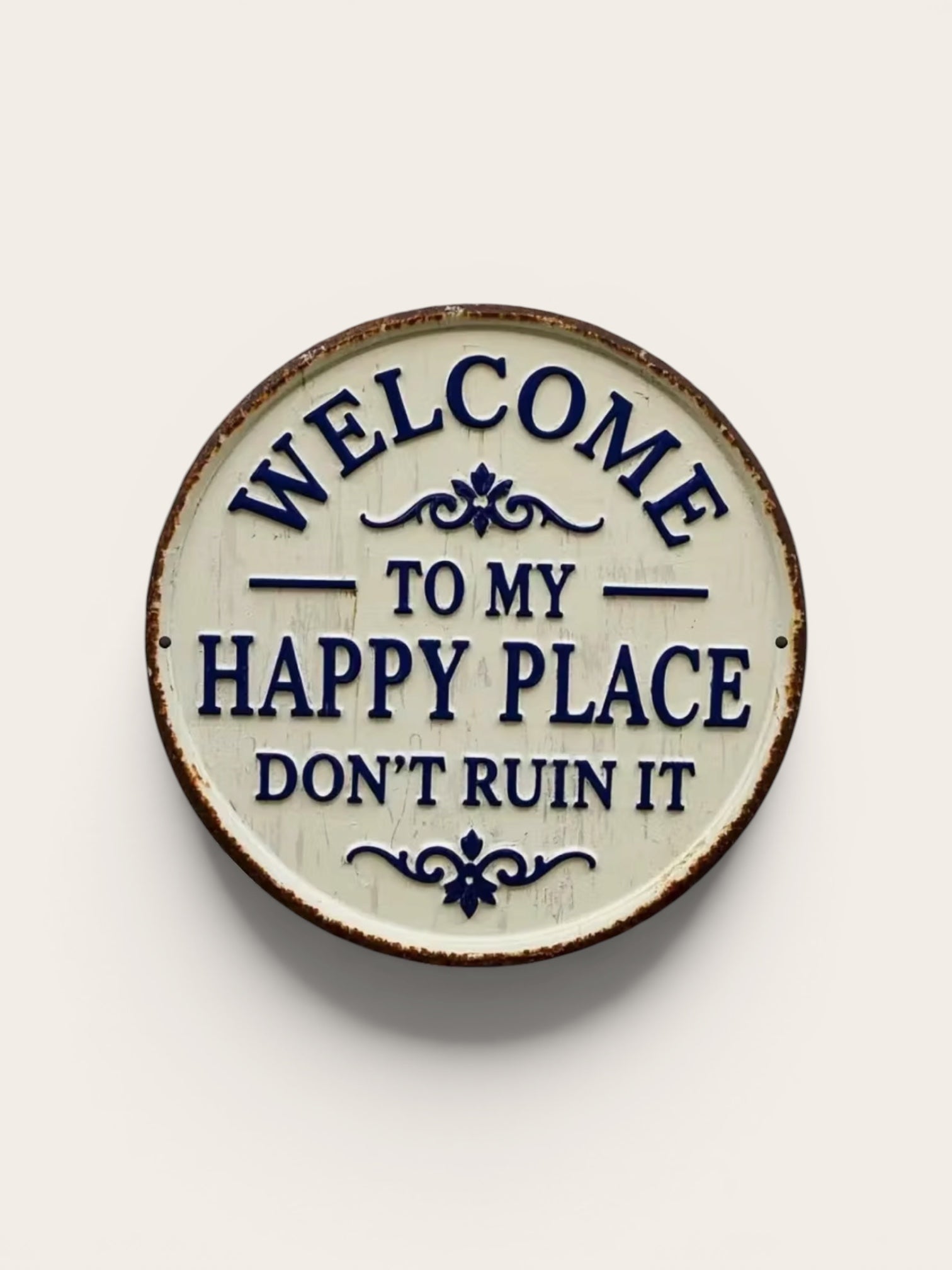 Decorative plate with text 'Welcome to my happy place don't ruin it' on a beige background