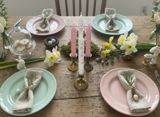 Easter-themed table setting with pastel colors and decorative elements on a wooden table.